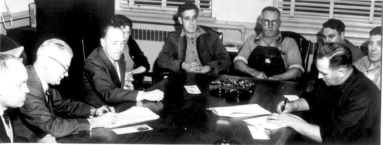 Men in 1960s sitting around table